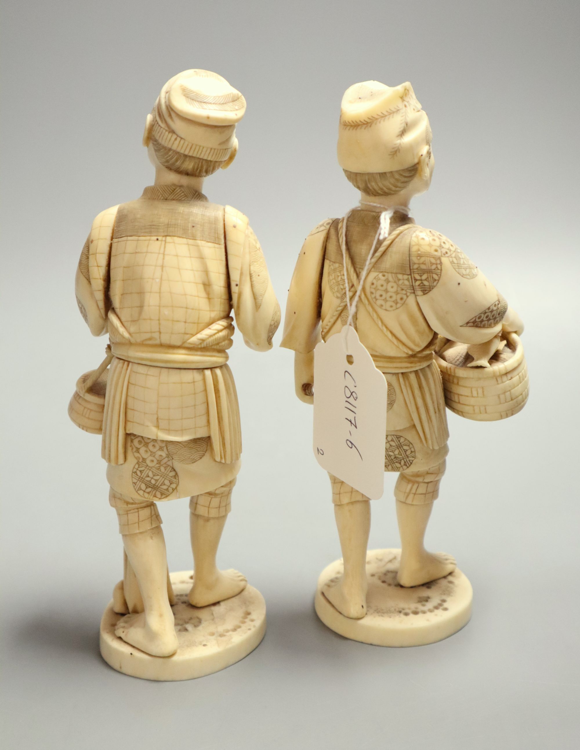 Two late 19th century Japanese okimono carved ivory figures of fishermen, height 19cm